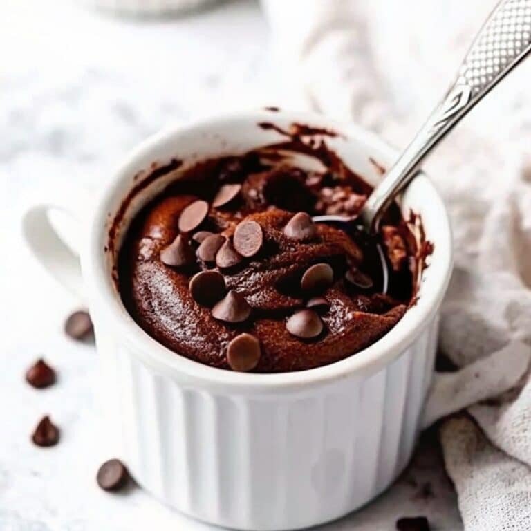 High-Protein Mug Cake Recipe That’s Quick, Delicious & Nutritious 5 High-protein mug cake in ceramic mug with toppings
